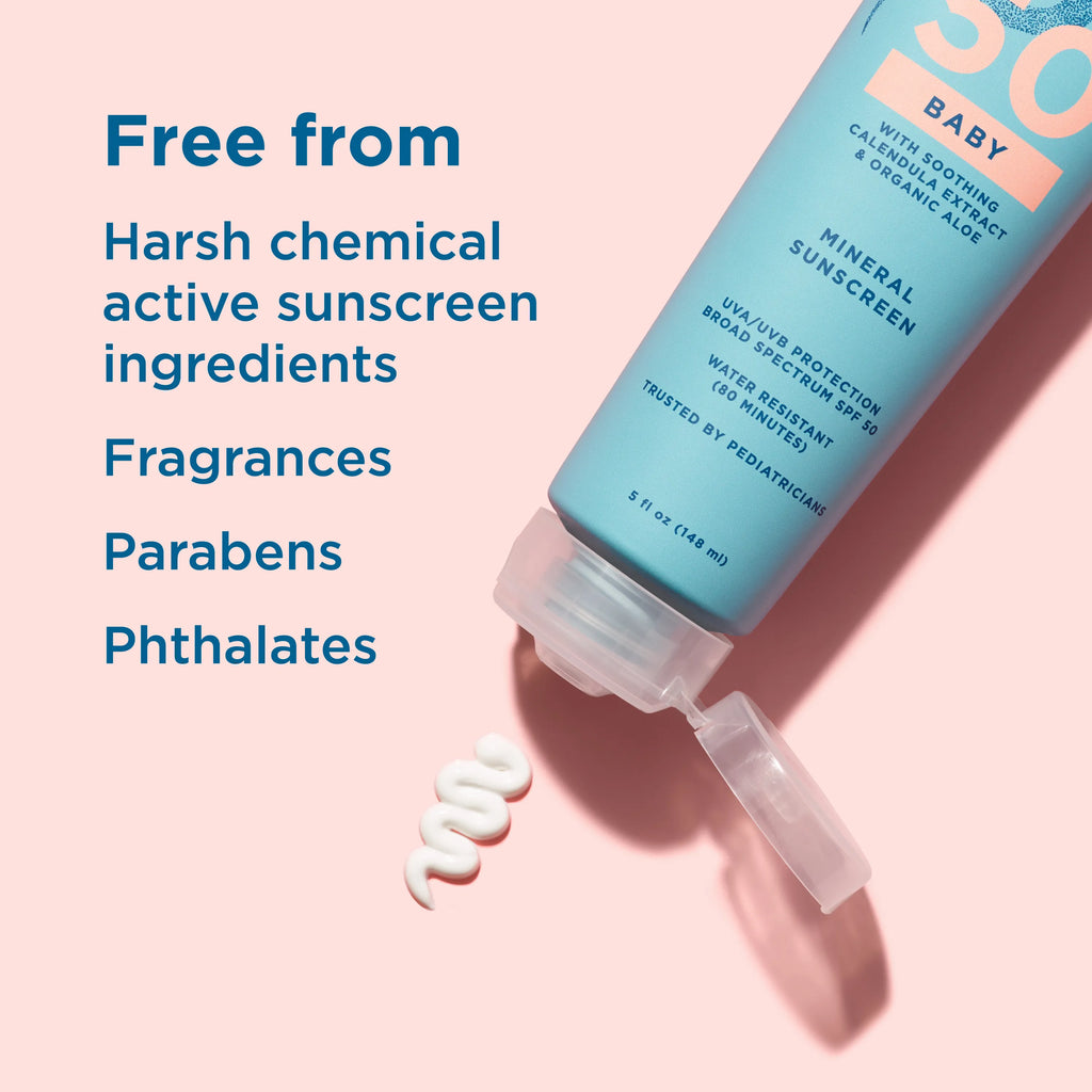 Baby sunscreen bottle with text highlighting ingredients on a pink background